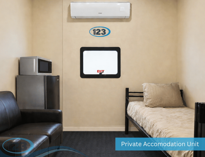 Private bed and lounge area inside a 20 ft VIP mobile sleeper trailer